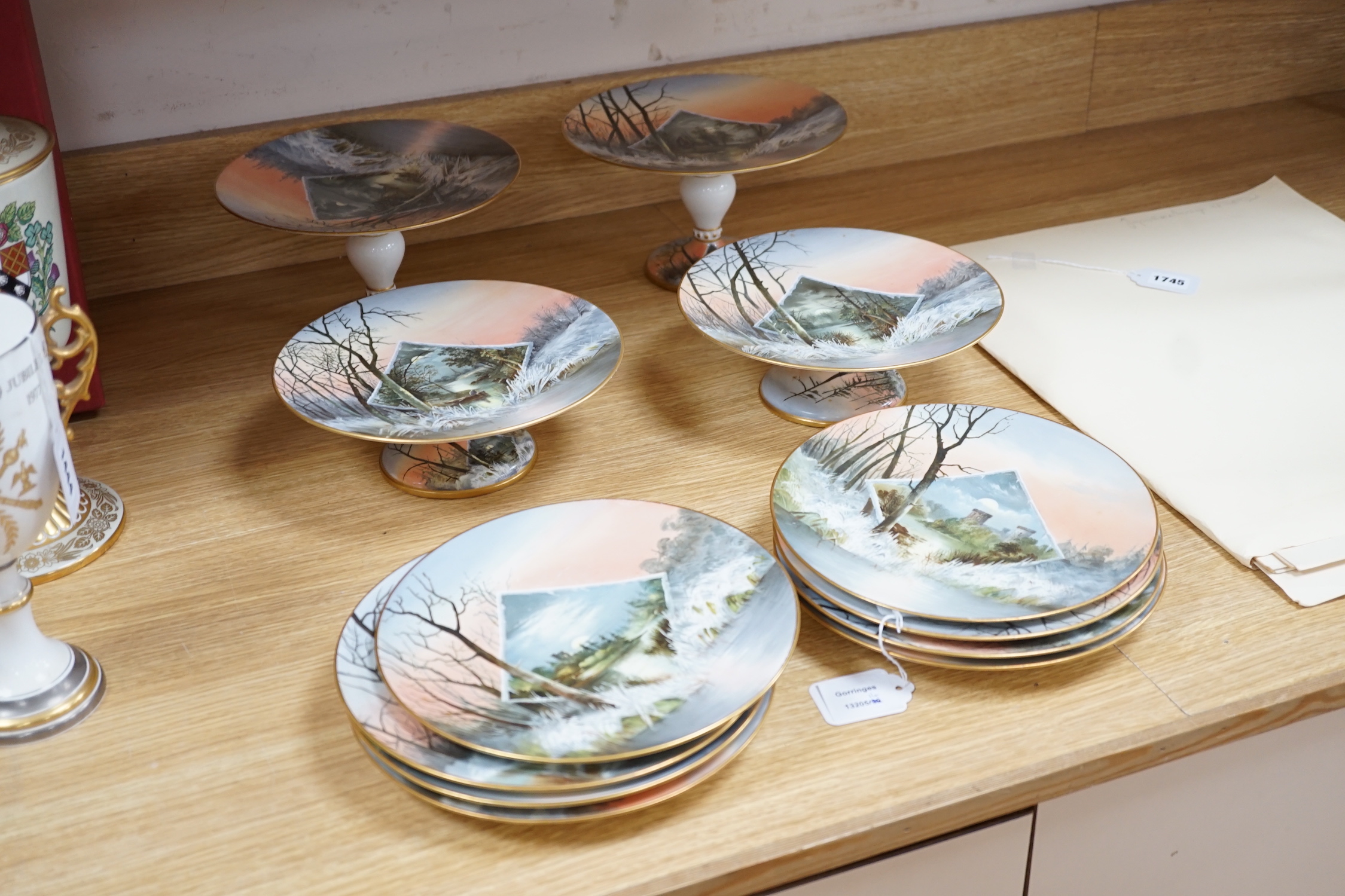 An English porcelain twelve piece dessert service, c.1875, painted with moonlit winter scenes, comprising of eight plates and four pedestal serving dishes, diameter of plates 22.5cm